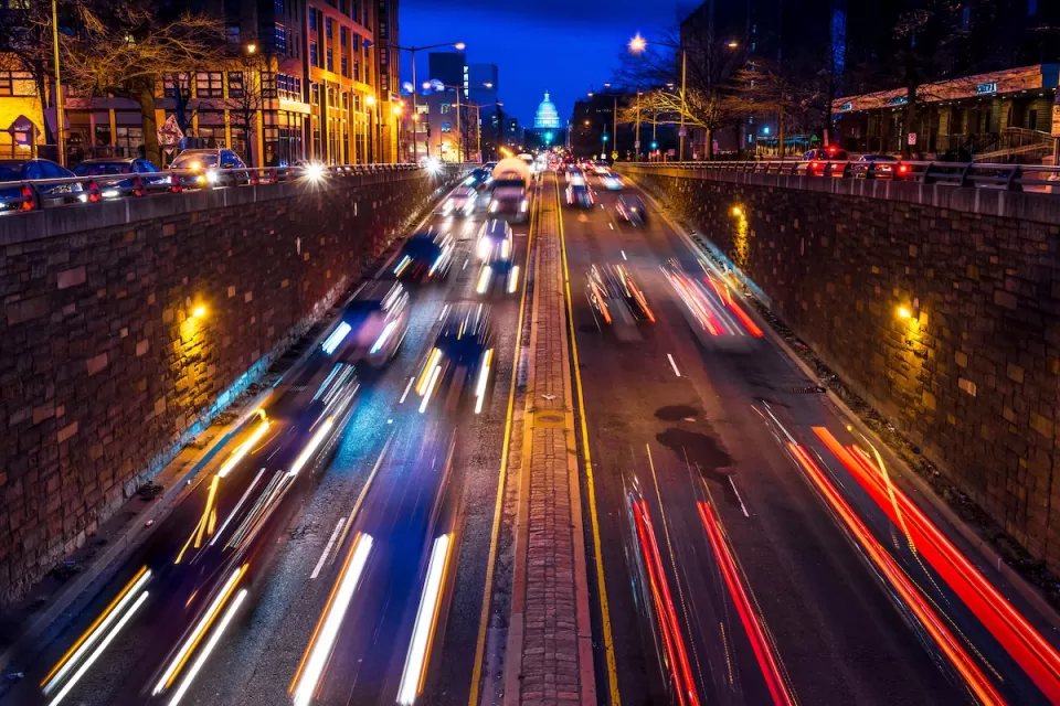 Nighttime view of blurred fast car traffic on street leading to U.S. Capitol dome in Washington, D.C.